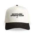 Black-and-cream hat with ‘Hustlers Sports Club’ text and a small lightning bolt logo centered on the front panel.